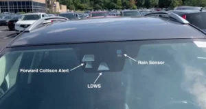 forward collision alert sensor, located in the front windshield third visor frit, next to LDWS sensor and rain sensor.