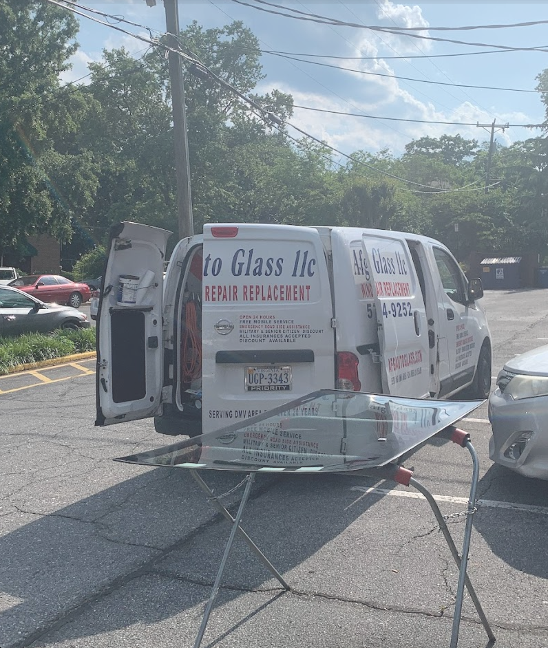 AFG Auto Glass technician replacing a windshield at customer location in Sterling, VA